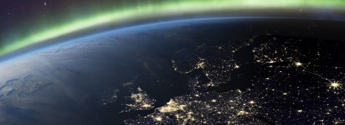 Planet Earth from the space at night and Northern Lights or Aurora Borealis related to the earth's magnetic field. Europe at night viewed from space with city lights. Elements of this image furnished by NASA