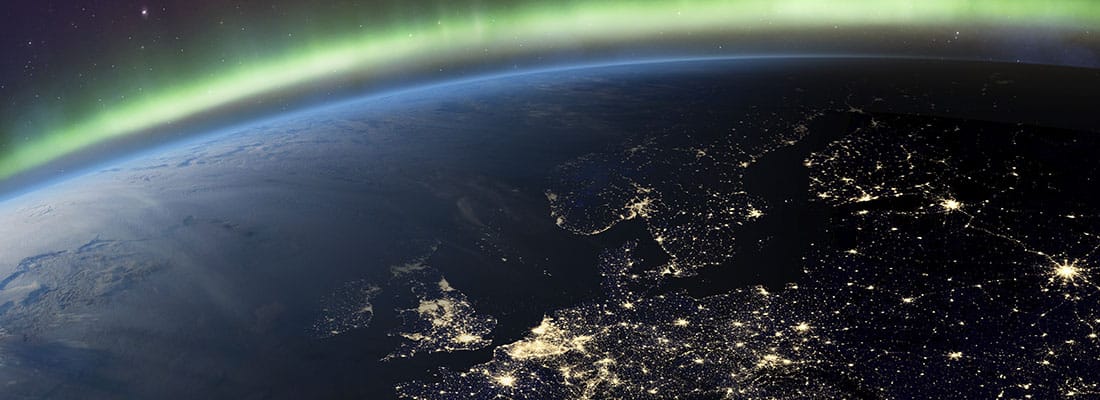 Planet Earth from the space at night and Northern Lights or Aurora Borealis related to the earth’s magnetic field. Europe at night viewed from space with city lights. Elements of this image furnished by NASA